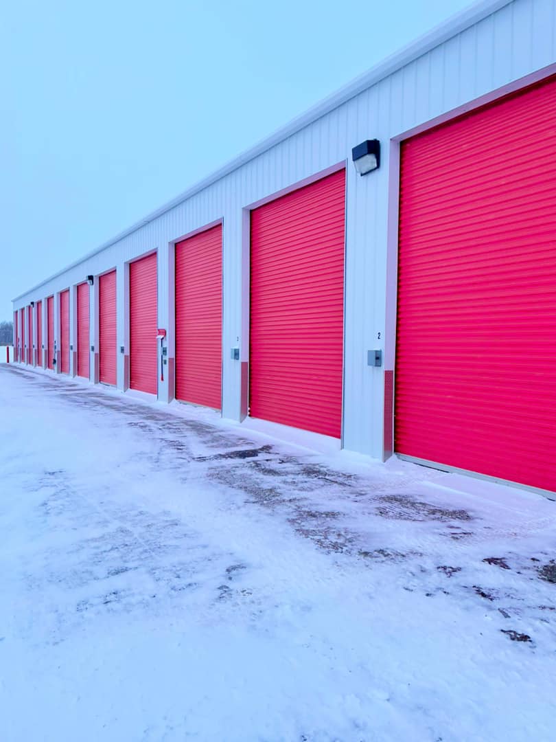 Maxim Storage facility in Grande Prairie featuring wide paved lanes and secure drive-up units in winter