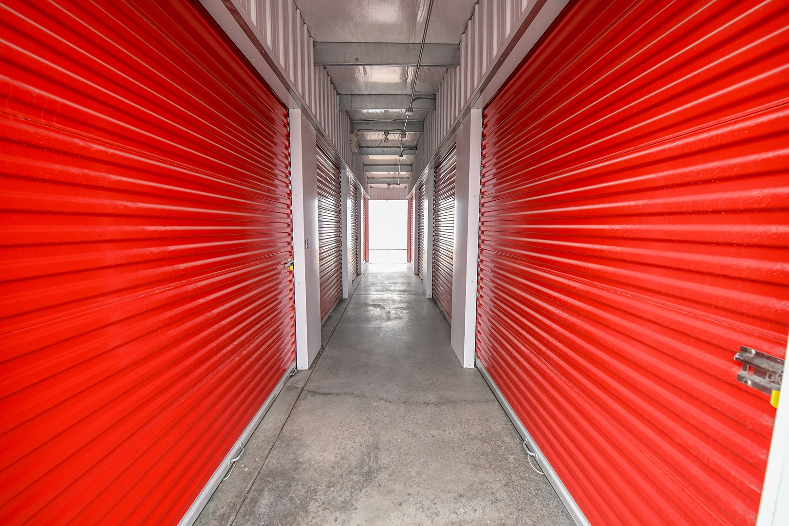 Clean, well-lit interior corridor at Maxim Storage showing secure unit doors